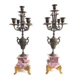 A pair of 19th century candlesticks, likely bronze, each with five scones above Art Nouveau detailed