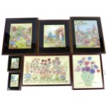 A group of vintage embroidered pictures, depicting cottage gardens and flowers, largest 29 by