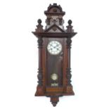 An early 20th century mahogany Vienna wall clock, 8 day movement chiming on a bell, with key, 40