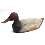 A vintage American decoy duck, mid to late 20th century, carved wood painted in shades of black,