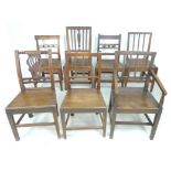 A group of seven Georgian and later dining chairs, all with solid seats and of varying design, one