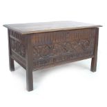 An Arts & Crafts 'Thrift Chest', with carved panels, and tapered legs, together with original