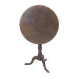 A George III mahogany tilt top occasional table, the circular surface raised on a turned support and