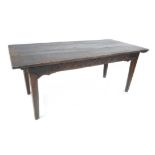 A 17th century oak dining table, the three plank surface believed to have been constructed from a