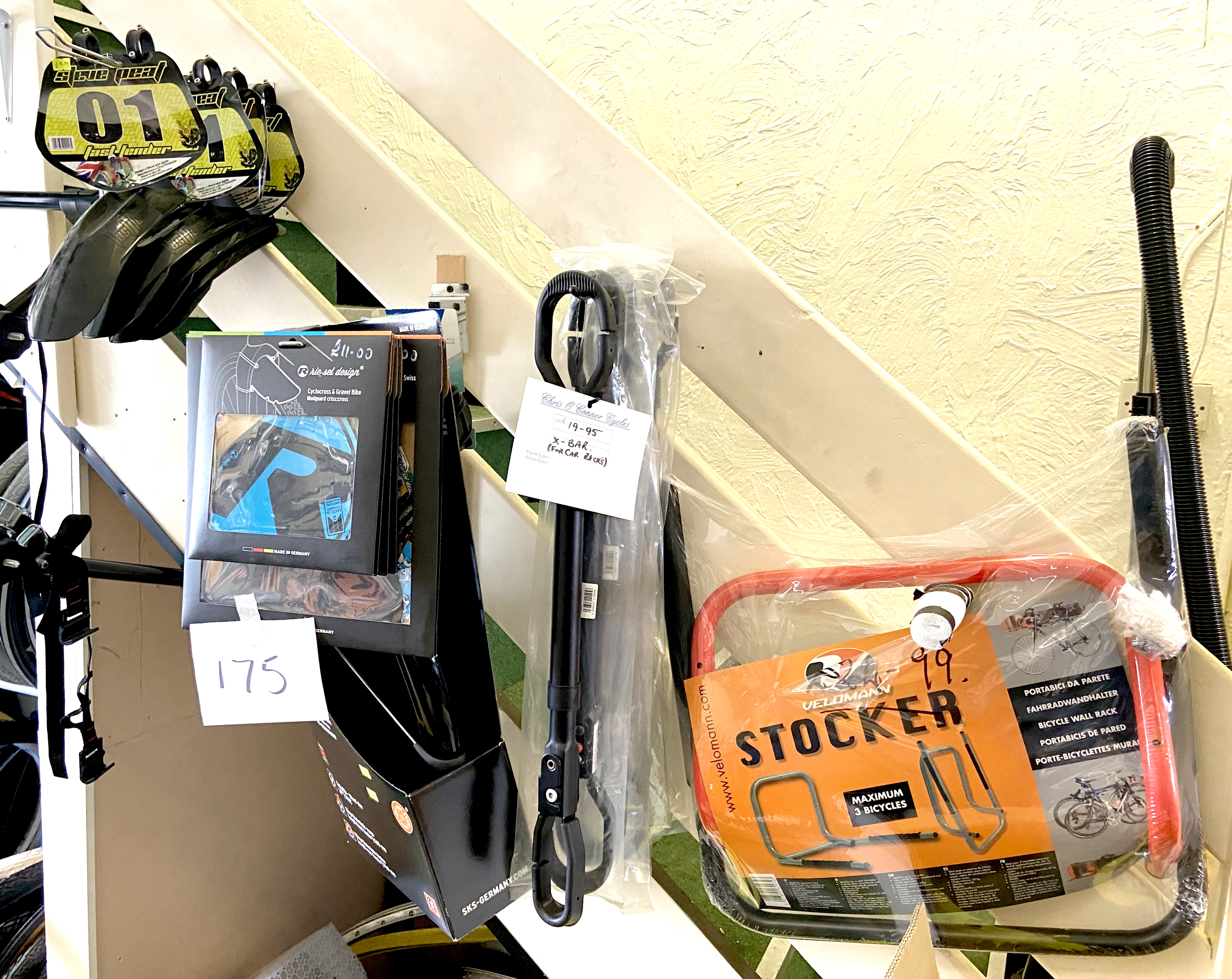 A Stocker wall mounting bicycle rack, four black X-bar (for car racks), and several boxed / packaged