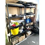 A pair of black plastic shelving units, with contents, including a quantity of child's bike tyres, a