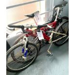 A Trek red painted gent's mountain bike, with dual suspension.