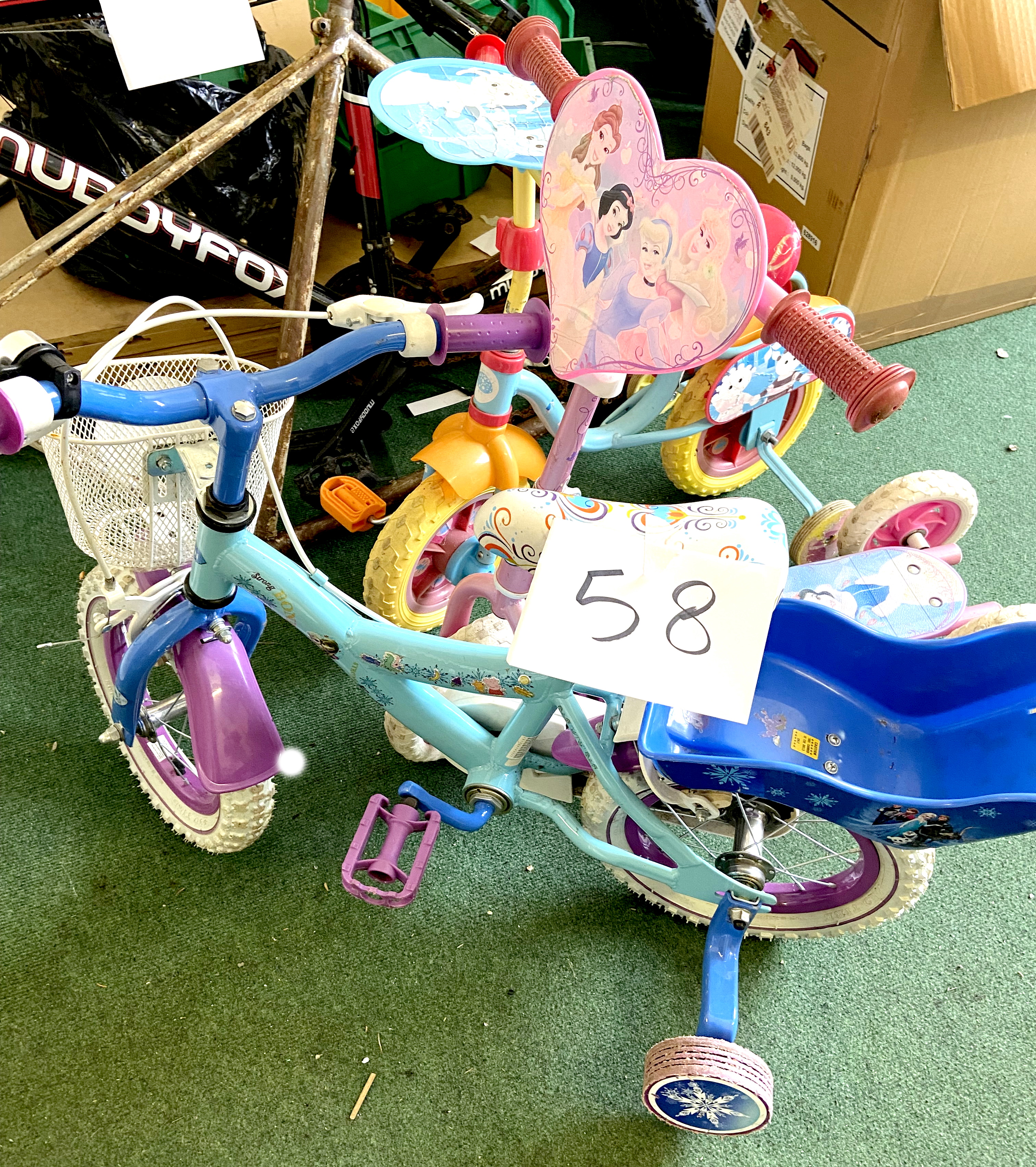 Two children's bikes, both with pale blue painted frames and stabilisers, together with a pink '