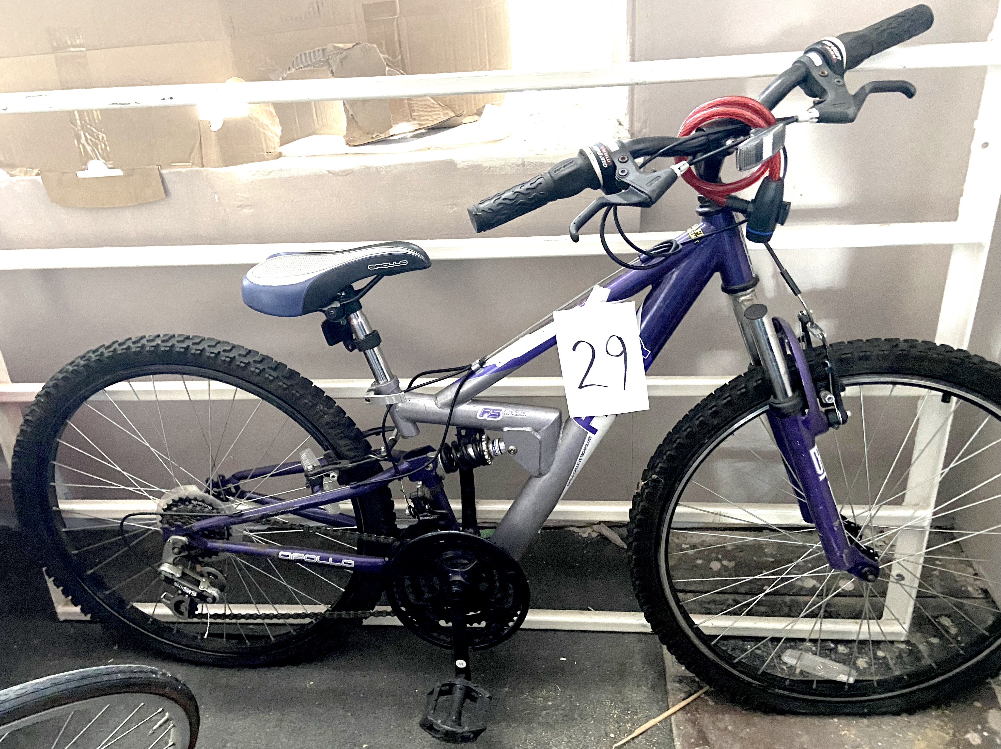 An Apollo FS29 silver and dark blue painted child's bike, with dual suspension.