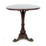 An Italian 19th century side table, the circular walnut surface with moulded edge, raised on a