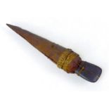 An early 20th century Papua New Guinea axe, the stone blade fitted in its carved wooden handle