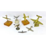 Seven cast metal models of WWI and later aircraft, including a brass Spitfire