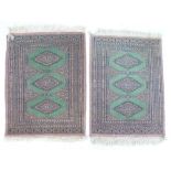Two small prayer rugs, in green and beige colours, 66 by 88cm. (2)