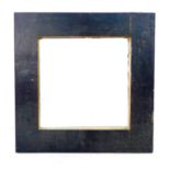 A modern wall mirror, square plate deep set in a wide black painted wooden frame with gold painted