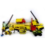 A collection of Tonka and other construction toys, including a Tonka Car Carrier with original