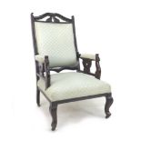 An Edwardian mahogany show frame armchair, with cream upholstery, cabriole legs with castors, 59