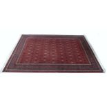 A Royal Keshan woollen rug, with red central ground, blue and caucasian ground borders, 275 by