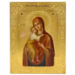An early 20th century Russian gilded and painted icon of the Holy Mother and Child, titled in