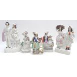 A group of five Staffordshire flatback figurines, comprising a figure of a gentleman holding a