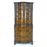 A 20th century serpentine front mahogany tall boy, chest of chest, in two sections, with dentil