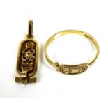 Two pieces of Egyptian gold jewellery, comprising a ring and a charm, tests as equivalent to 18ct,