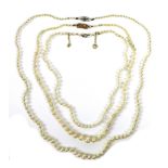 A group of three pearl necklaces, the first a with diamond solitaire clasp of approximately 0.
