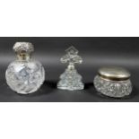 Three silver topped dressing table items, inclduing a spherical scent bottle with hinged silver