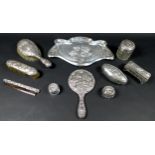 Ten pieces of Edwardian silver dressing table items, all decorated with repousse cherubs after