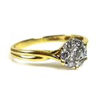 An 18ct gold and diamond cluster ring, formed of a central brilliant cut diamond encircled by six