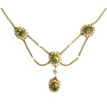 An Edwardian 15ct gold, seed pearl and green stone festoon necklace, each stone approximately 6 by
