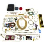 A group of costume jewellery, comprising necklaces, brooches, earrings, bangles, rings, coins and