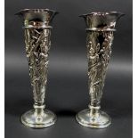 A pair of Victorian silver spill vases, with flared rims and enbossed floral designed stems and