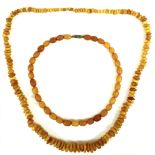 Two amber necklaces, one formed of unpolished graduated butterscotch beads of irregular shape,