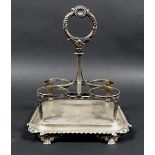 A George III silver cruet stand, with shell mounted handle, monogram to base and scroll decorated