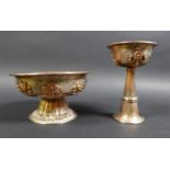 Two similar Tibetan copper and silver plated footed bowls, 19th or early 20th century, decorated