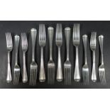 A set of twelve Edwardian silver rat tail pattern forks, comprising six table forks, 19.5cm long,