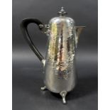 An Edward VII silver hot water or chocolate pot, in Arts & Crafts taste, of tapering cylindrical