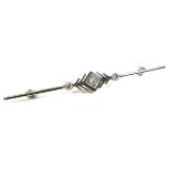 An Art Deco 18ct white gold and platinum bar brooch, set centrally with a 2mm round cut diamond,