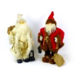 Two Father Christmas model ornaments, comprising a Sia Father Christmas model in white holding a