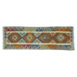 A Maimana Kilim runner, autumnal colours, with four central diamond lozenges encased in a white