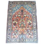 A Mahal rug on salmon pink ground, featuring multiple floral bouquets to central panel and