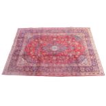 A Mahal rug, red ground and densely decorated with floral and foliate detail, dark blue central