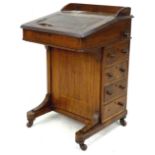 A late Edwardian Davenport with 4 drawers and secret pen compartment on castors. a/f, 52 by 53 by