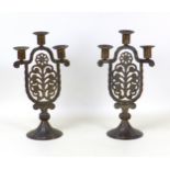 A pair of Hugo Berger GOBERG Jugendstil cast iron candelabras, each with three branches and