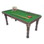 A 20th century oak snooker/dining table in need of restoration, with removable oak top, adjustable