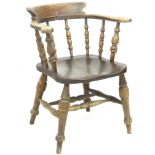 An early 20th century ash and elm smokers bow chair, former WWII RAF use, stamped 'AM' and 1935 to