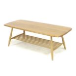 An Ercol beech and elm coffee table, circa 1960, the surface of rectangular form with rounded