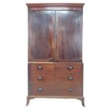 A 19th century mahogany linen press cupboard over three drawers, raised on bracket feet, 122 by 62