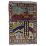 An Old Baluchi rug, depicting a mosque in the foreground with a mountainous landscape, with repeated