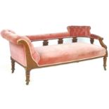 A Victorian mahogany chaise longue, upholstered in pink fabric, on castors, 170 by 70 by 76cm high.